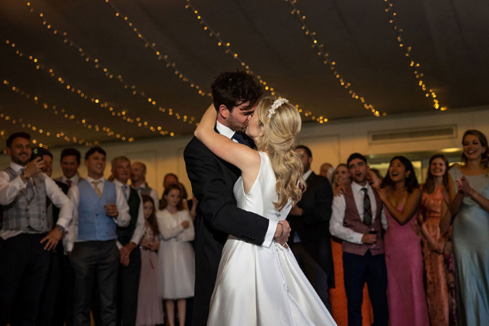 Bride and groom kiss during their first dance