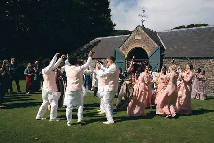 A group of people dancing in a field at Byre at Inchyra.