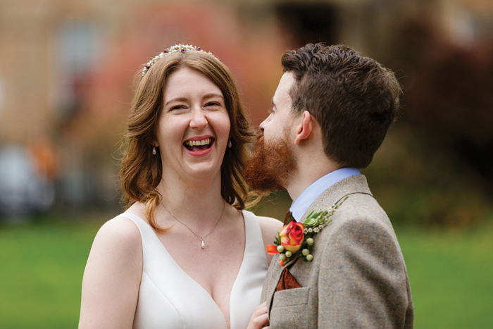 Bride laughs during couple portraits