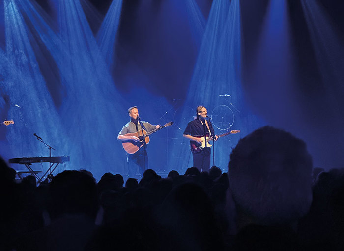 Band standing on stage performing