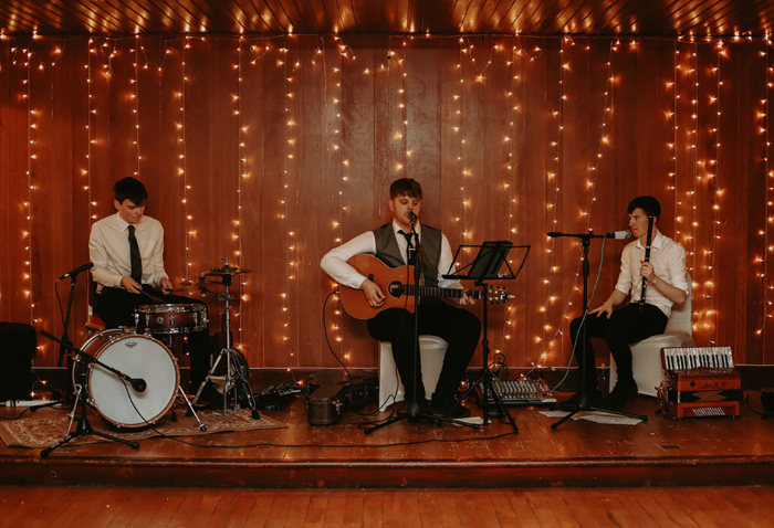 Band plays against backdrop of fairylights