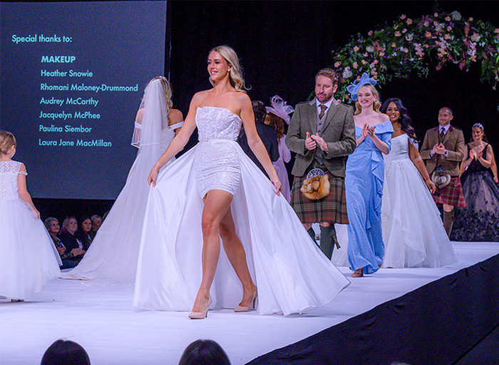 Models walking in wedding clothes on a catwalk 