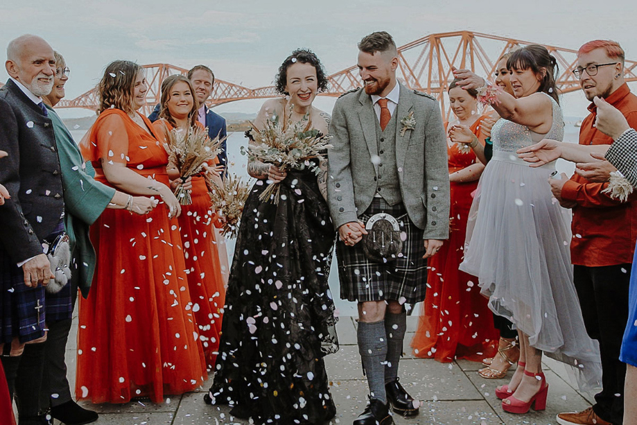 Couple walk through confetti shower