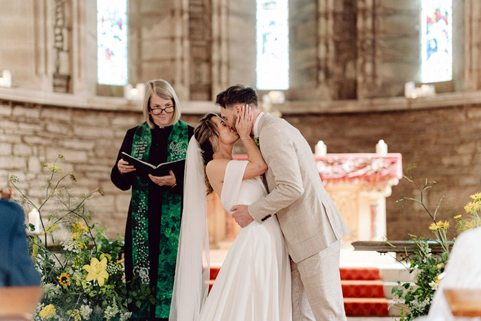 bride and groom kiss during wedding ceremony at drumtochty castle