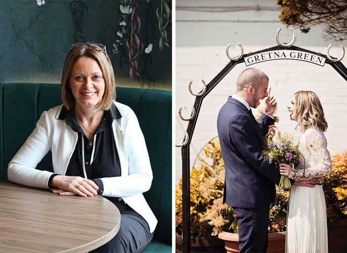 a person sitting at a round wooden table on a teal upholstered chair and dark floral wallpaper on left. A bride and groom standing looking at one another under an arch shaped frame that reads 'Gretna Green'