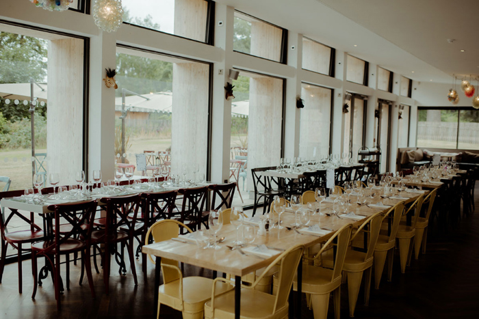 Long tables set up for dinner in The Restoration Yard