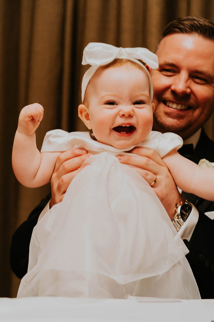 a person holding a smiling baby.