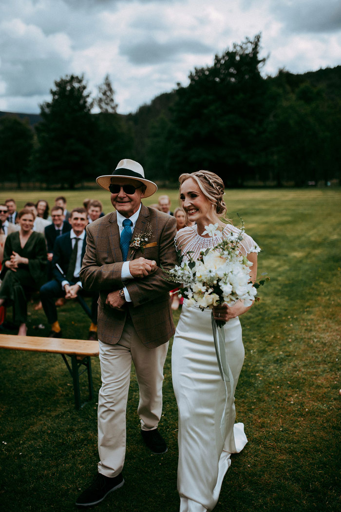 bride walks down the aisle at mar lodge