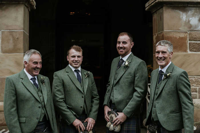 A Groom And 3 Groomsmen Outside Cornhill Castke