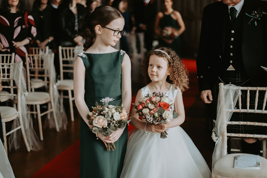 Bridesmaid and flower girl walk down the aisle