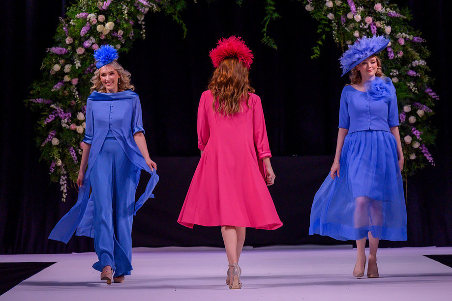 three models wearing Joyce Young Collections occasion wear outfits on the catwalk at the Scottish Wedding Show