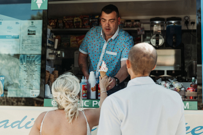 Ice cream vendor giving the newlyweds a cone 