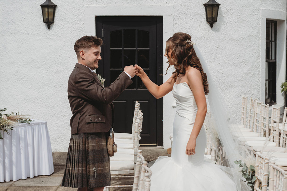 Bride and groom fist bump during first look