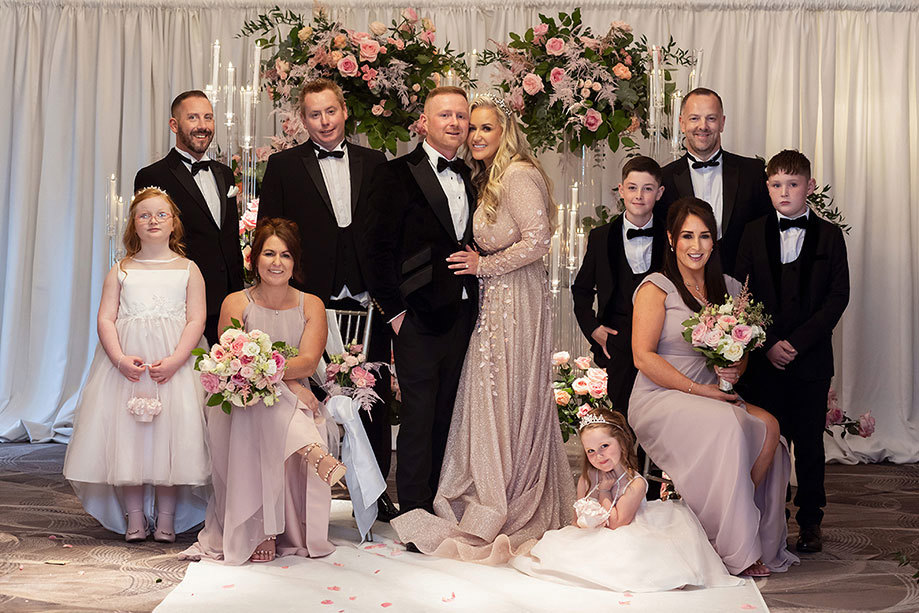 a group of people posing for a photograph during a wedding at the Torrance Hotel