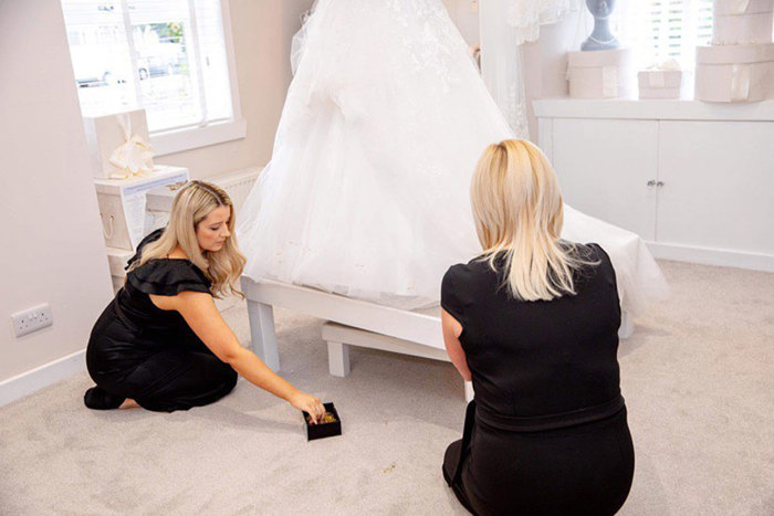 Two women kneeling on the floor. 