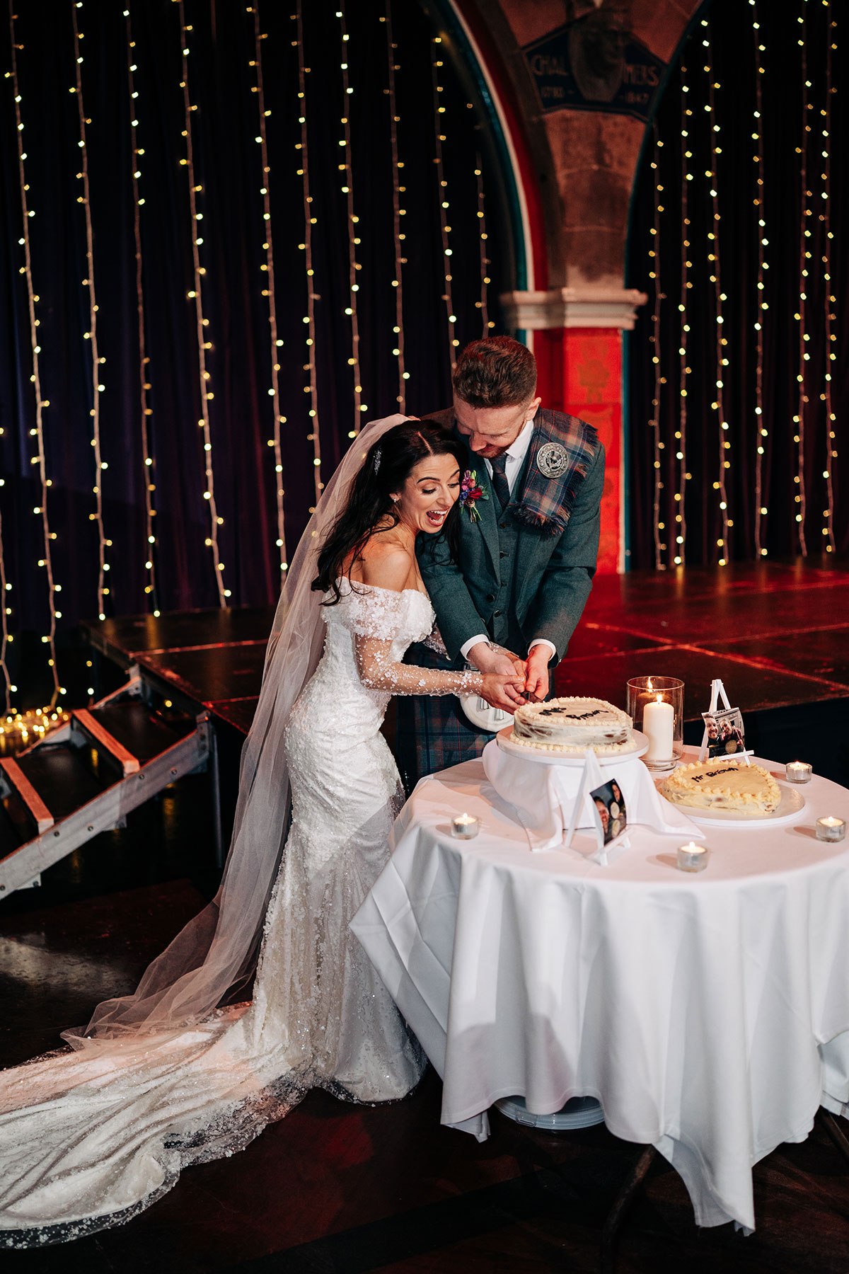 bride and groom cut wedding cake at oran mor