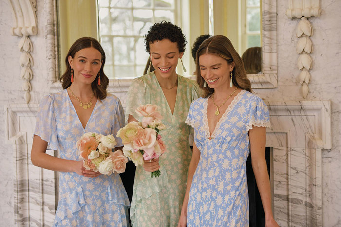 Models wearing colourful, floral-patterned RIXO dresses