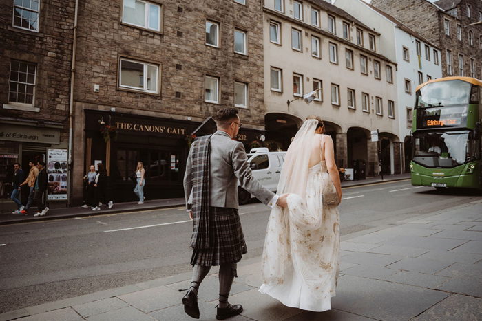 Couple walk towards tattoo studio