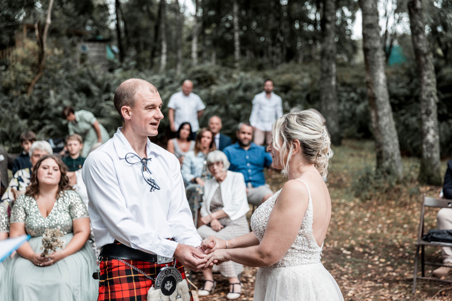 Couple hold hands during ceremony