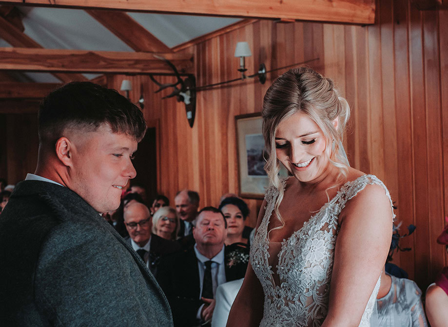 a bride and groom holding hands during a wedding ceremony at Rottal Steading