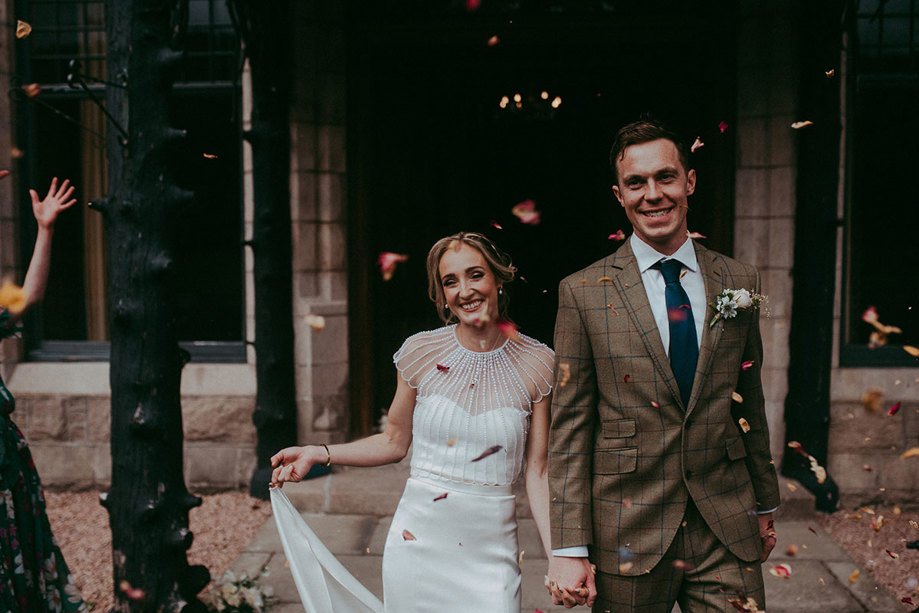 bride and groom leaving mar lodge to greet guests