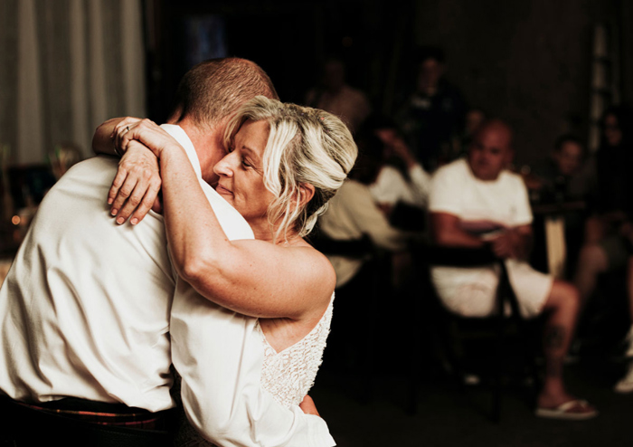 Bride and groom embrace on the dancefloor