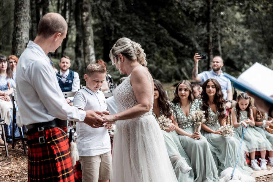 Couple hold hands during ceremony