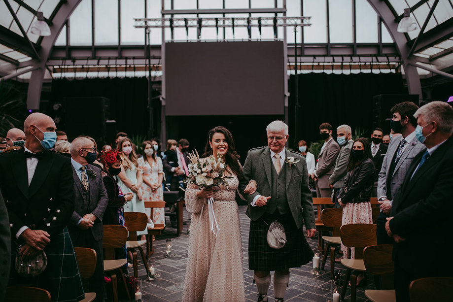 Bride walks down the aisle at Barras Art And Design Baad