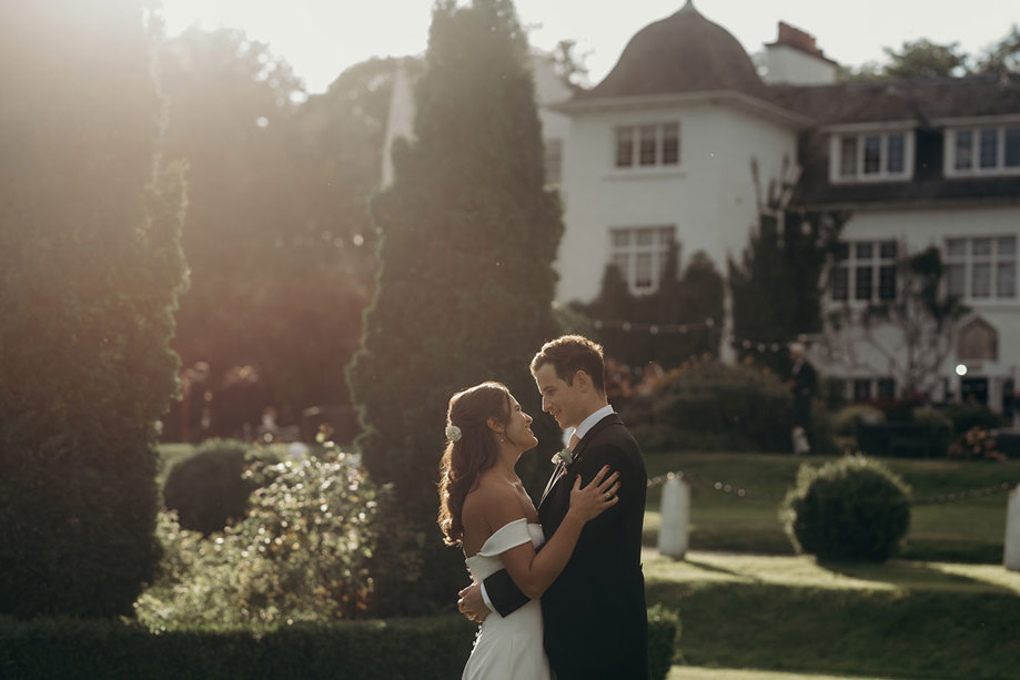 a bride and groom in hazy sunlight in the garden at Achnagairn Castle. 