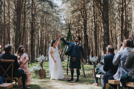 couple cheer after tying the knot in outdoor ceremony at harvest moon in dunbar