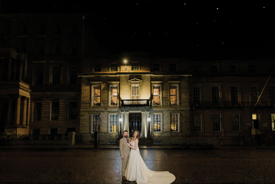 Couple outside 1599 at the Royal College for an evening shot