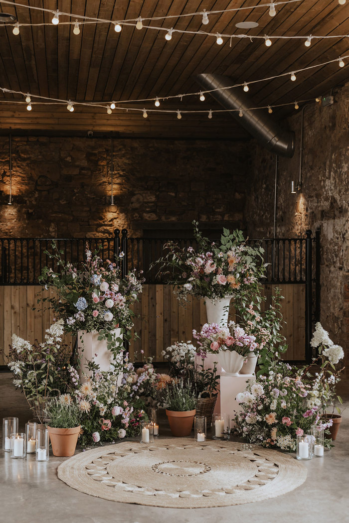 floral decor in vases at falside mill wedding