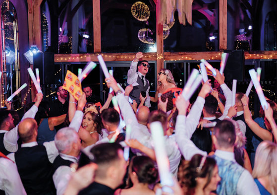 Couple and guests on wedding day on the dance floor