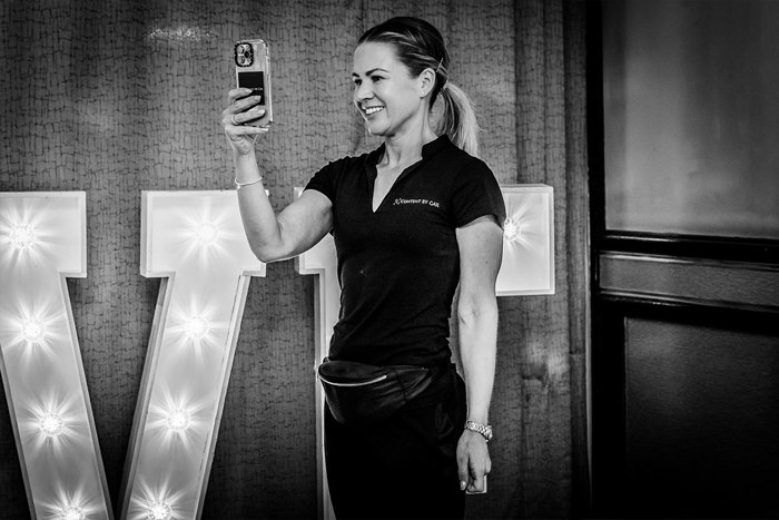 A wedding content creator filming using her phone
