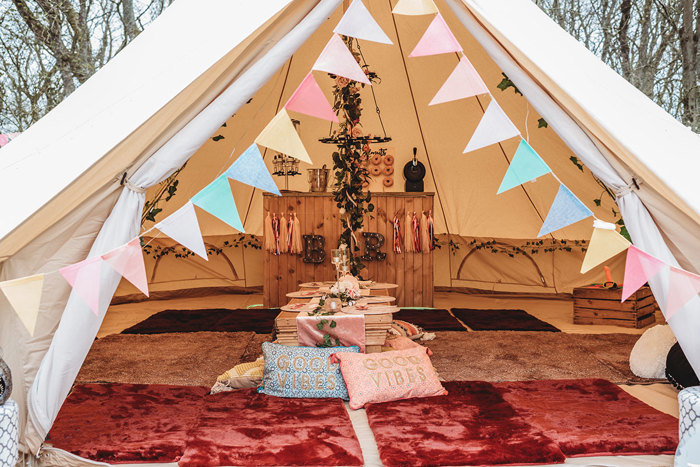 Interior of teepee with table set up in centre and bar at the back