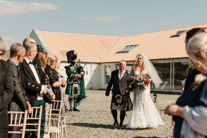 Bride walks down the aisle with her father