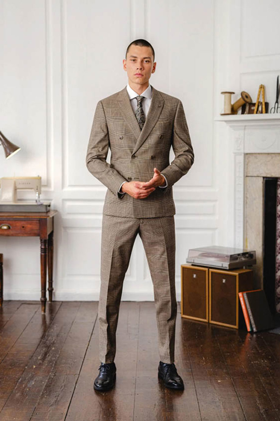 a model wearing a brown checked suit