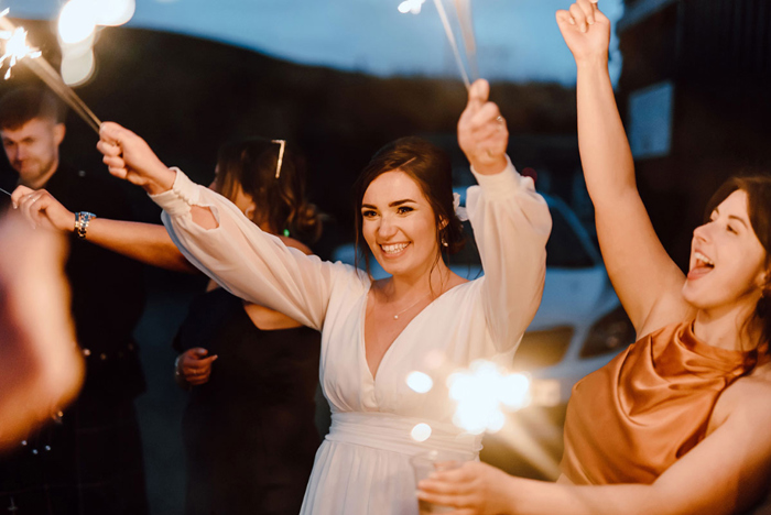 Bride smiling with sparklers