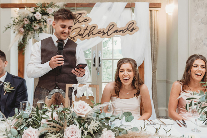 Bride laughs during groom's speech