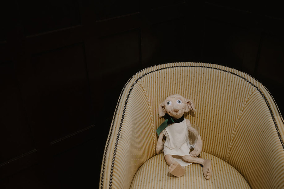 a Dobby stuffed toy sitting on a yellow and white striped chair.