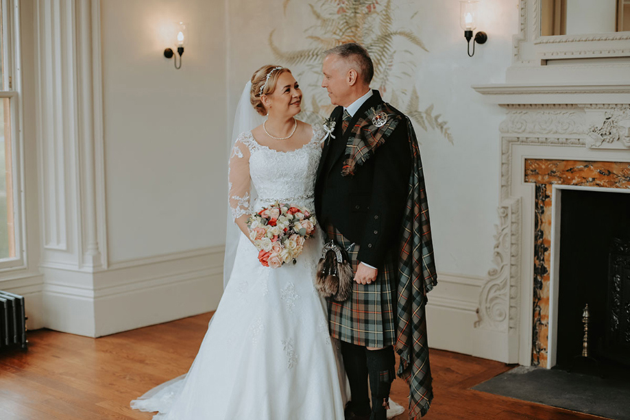 Bride and groom look at each other during their couple portaits