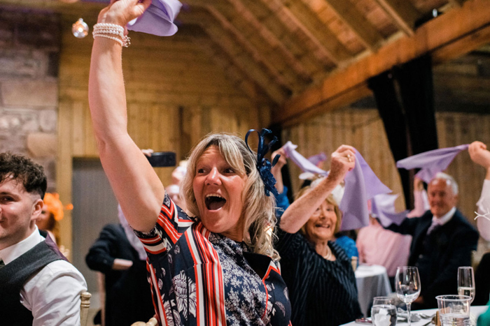 Guests cheering during wedding