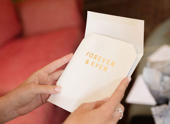 hands holding an order of service with 'forever & ever' written on front