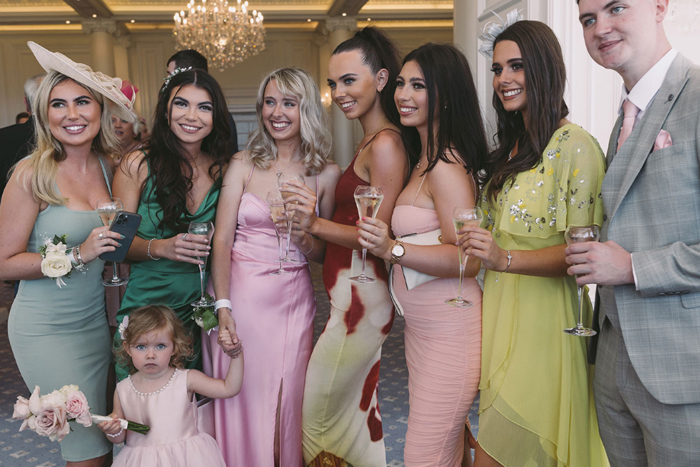 Guests and flower girl pose for a picture