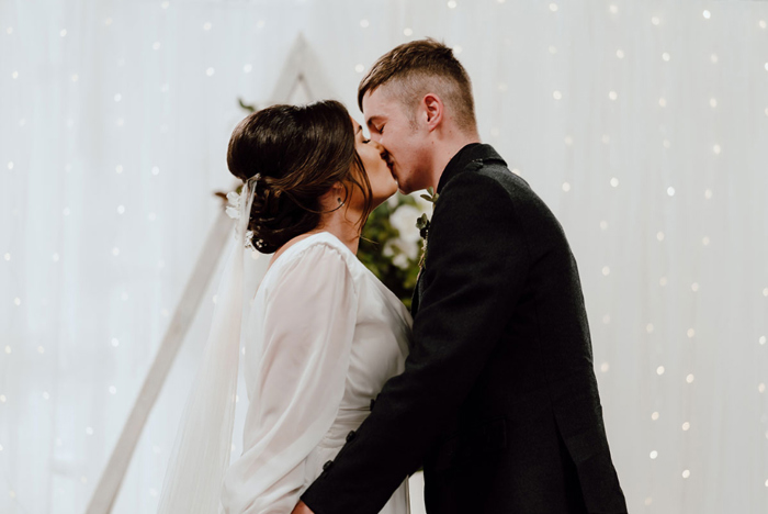 Bride and groom share a kiss