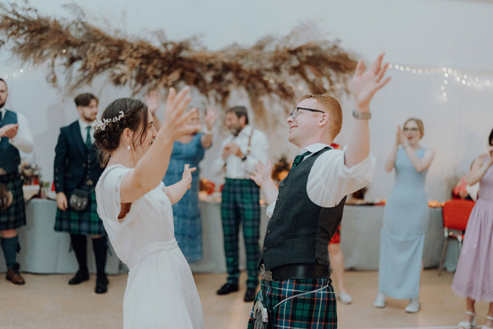 Couple dance in the middle of a circle of guests