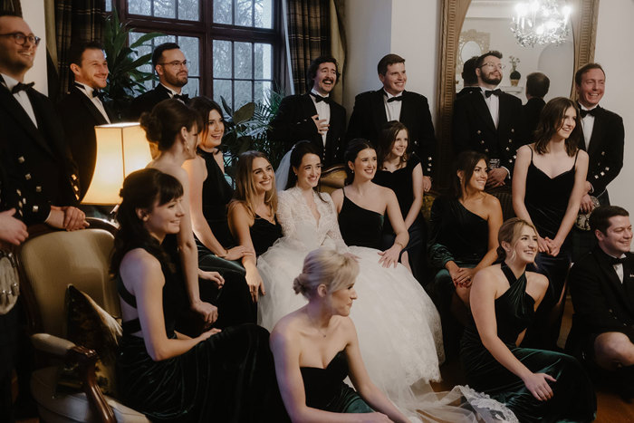 a group of people posing for a photo at a wedding.