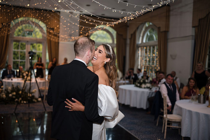 Bride and groom laugh during their first dance