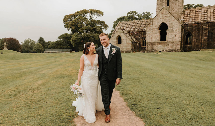 a bride and groom walking outside Dunglass Collegiate Church on Dunglass Estate