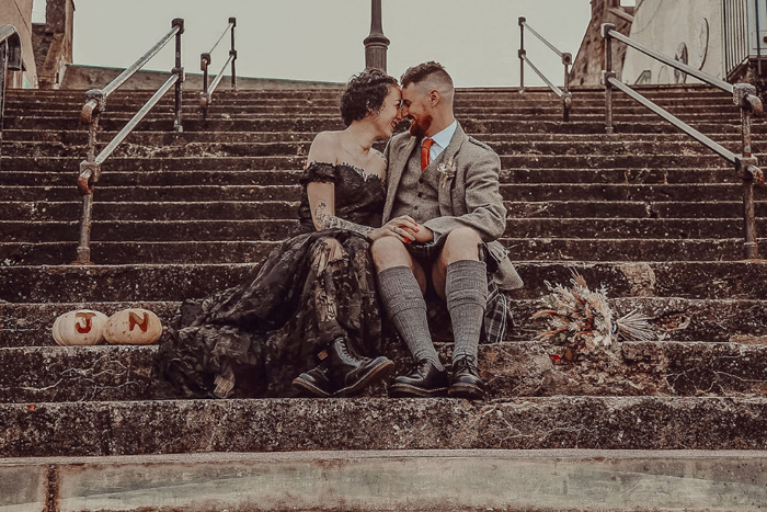 Couple sit on stairs during couple portraits